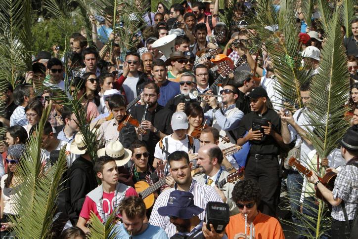 Christian pilgrims participate in the traditional Palm Sunday procession on Jerusalem's Mount of Olives. (photo credit: Miriam Alster/Flash90)