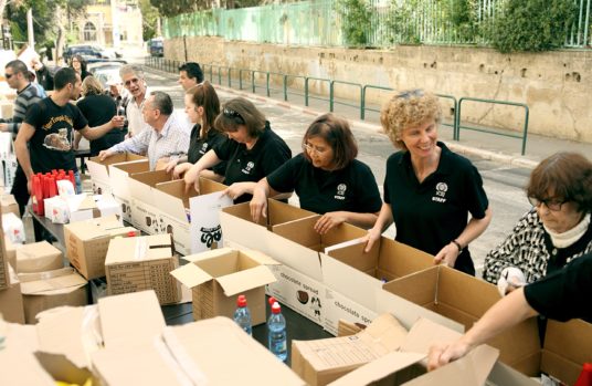 Distributing boxes for Holocaust Survivors