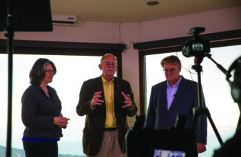 Nicole Yoder, Barry Denison and David Parson pray during Envision 22 conference