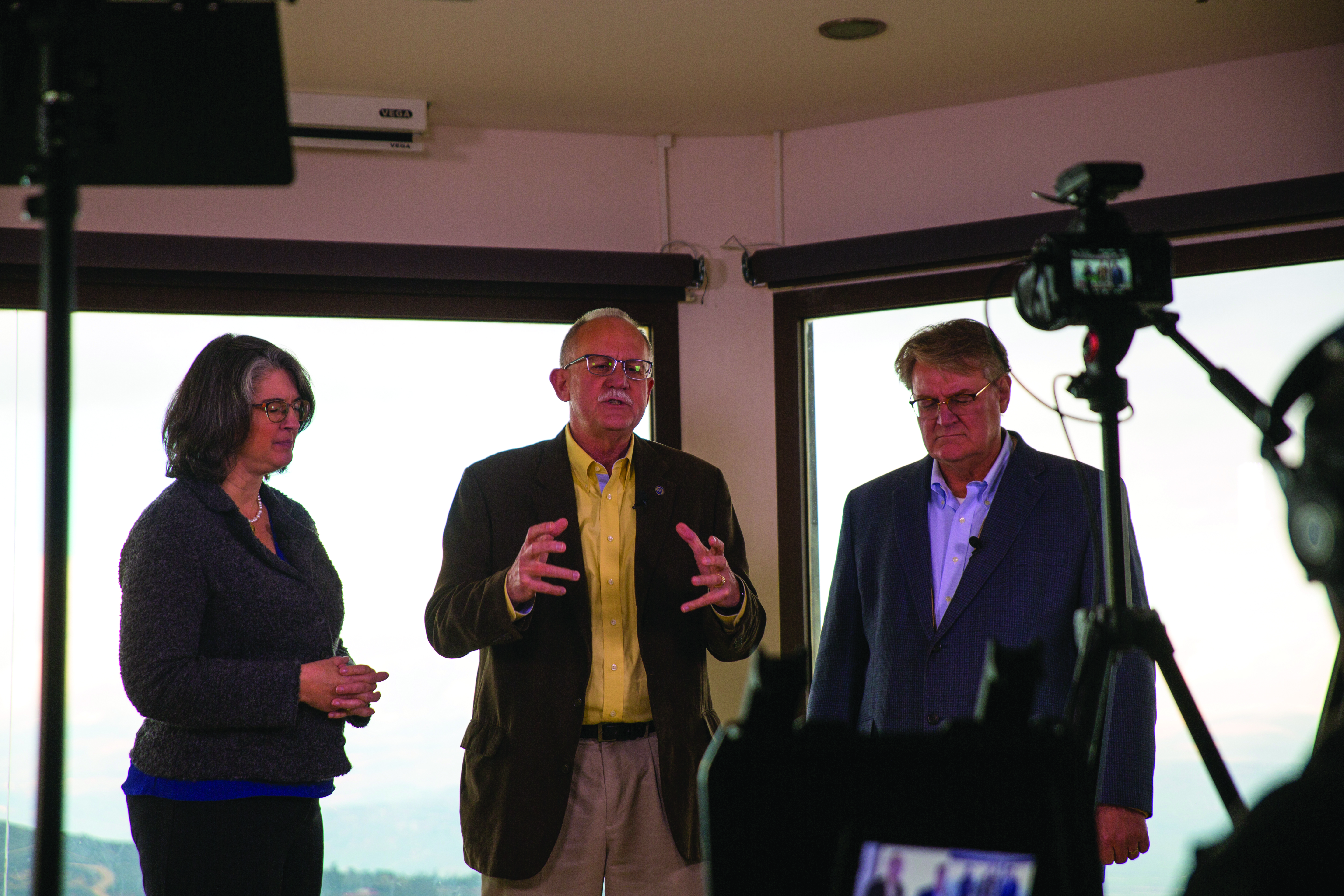 Nicole Yoder, Barry Denison and David Parson pray during Envision 22 conference