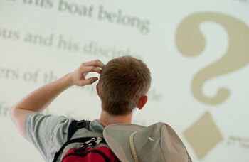 Man looking at question mark