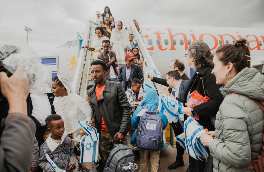 new immigrants exiting airplane