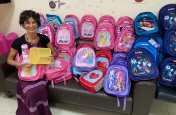 ICEJ AID Assistant with sponsored school bags