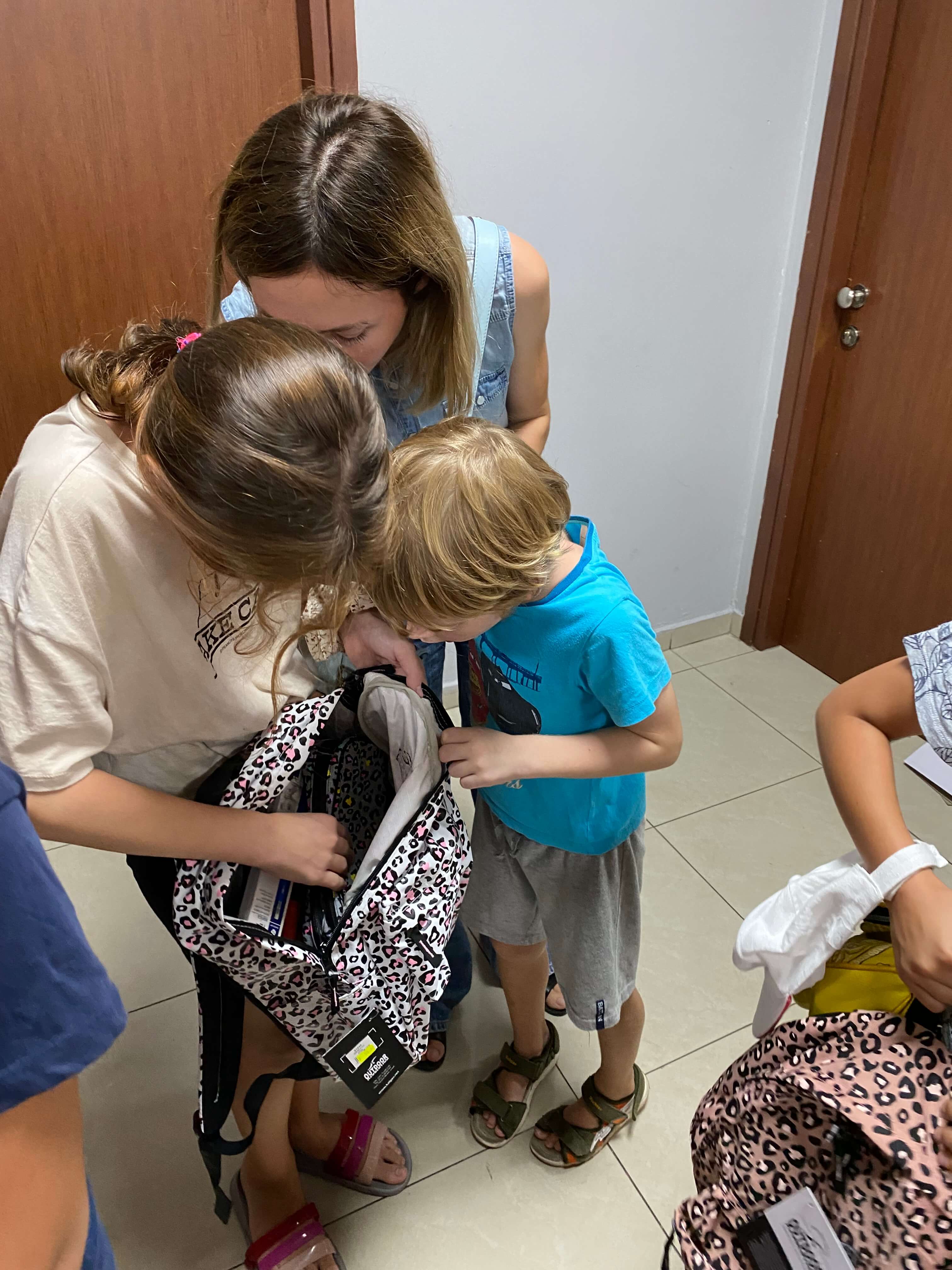 Child looking to see what is inside the backpack