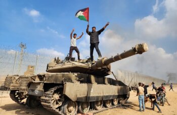 Hamas militiamen capture IDF tank on October 7. (Credit: Getty Images)