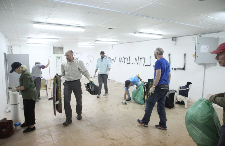 Christian volunteers renovate a bomb shelter during an ICEJ Hands-On Tour