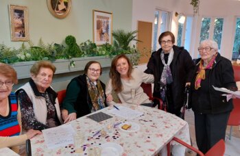 Christine is surprised during the weekly Bingo activity.