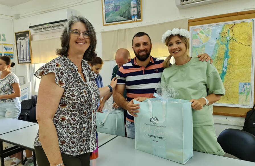ICEJ VP of Aid and Aliyah Nicole Yoder (L) hands a gift bag to new immigrants.