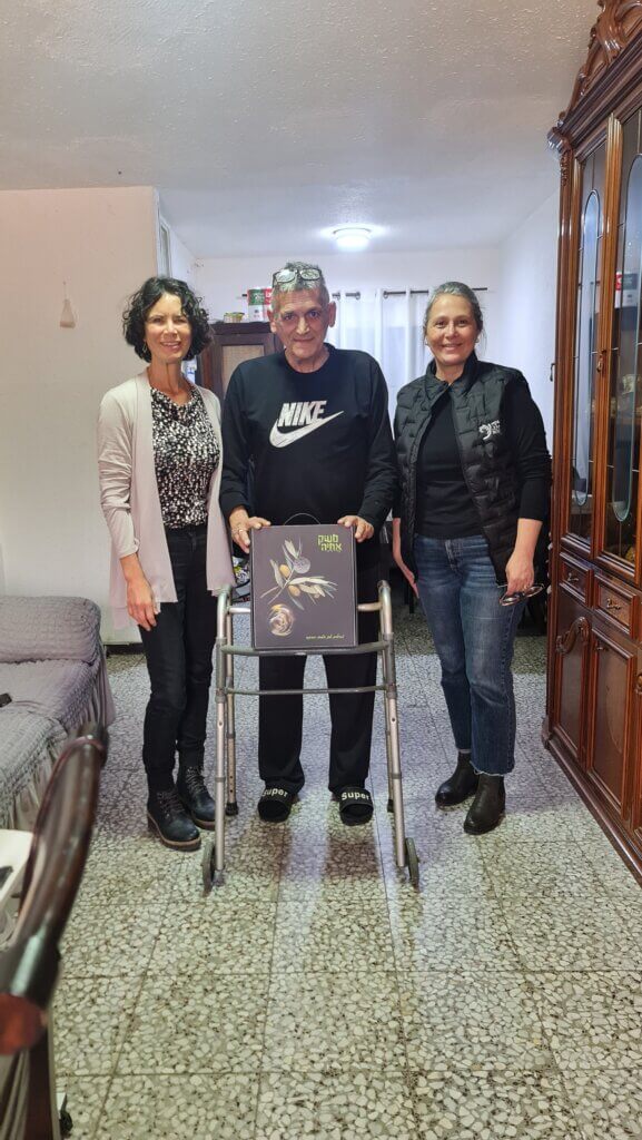 Rafi and ICEJ staff with his Pesach gift