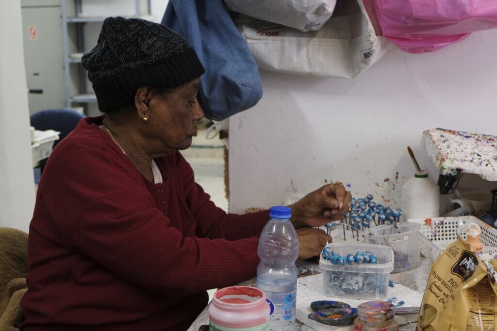 Elderly lady prepares beads