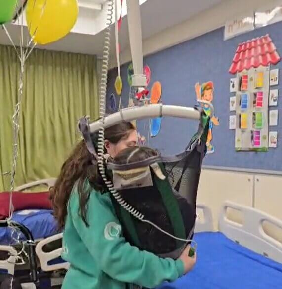 Disabled child in specialised lift sponsored by ICEJ