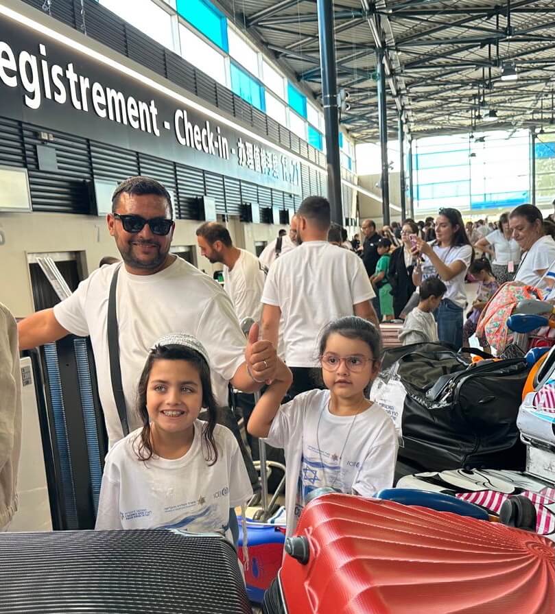 French family waiting to board their ICEJ-sponsored flight