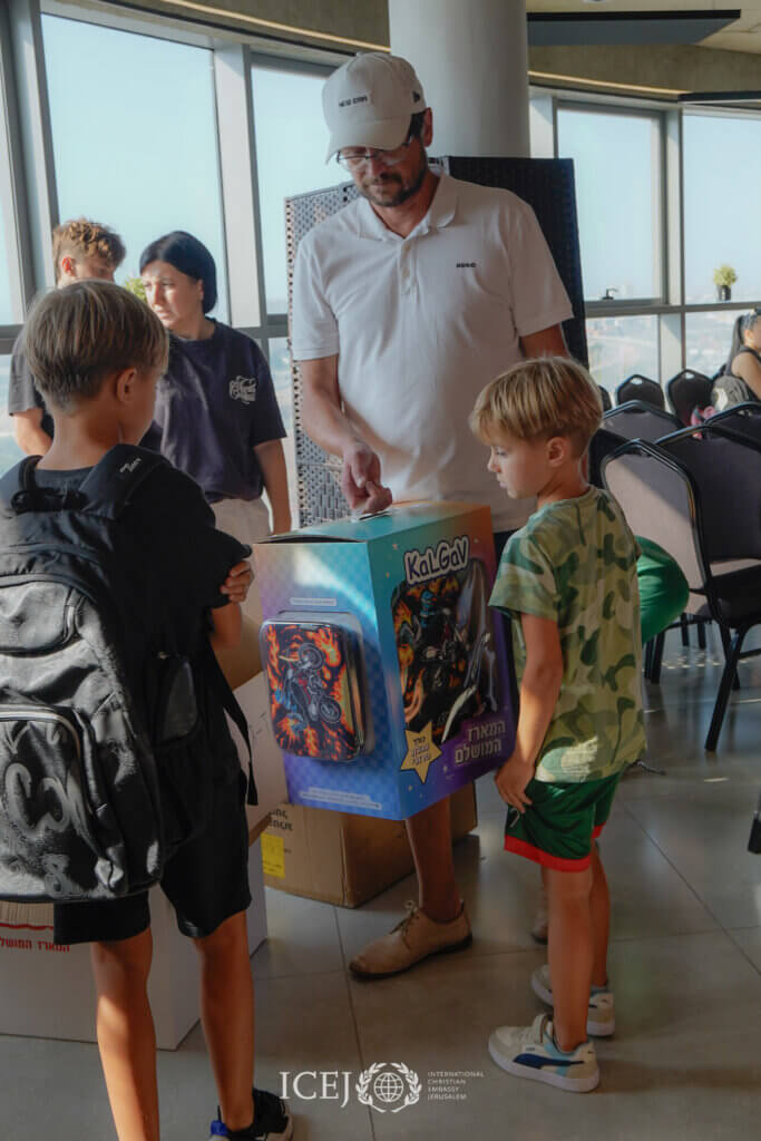 Father with children receiving backpack