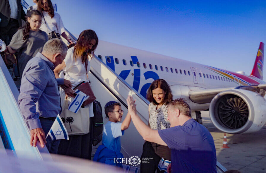 A little boy gives David Parsons a high-five as he disembarks the flight