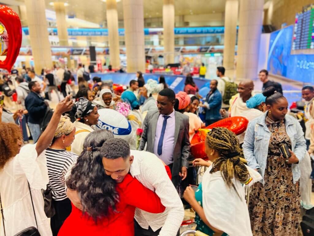 Ethiopian families embrace at the airport