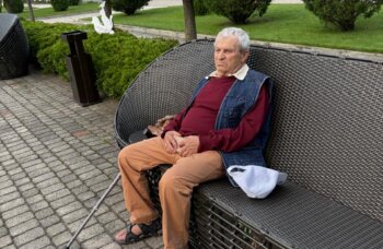 Yefgenia sits on a park bench during his daily walk